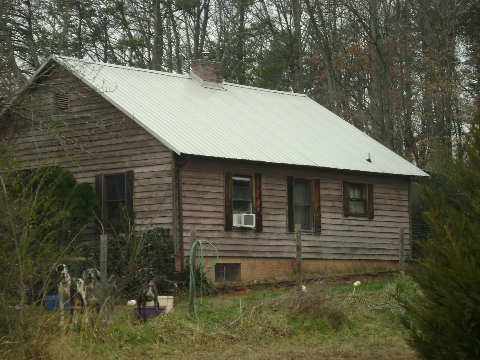 White metal roof on an old wood sided farmhouse, from a Metal Roof Installation job in Lamona
